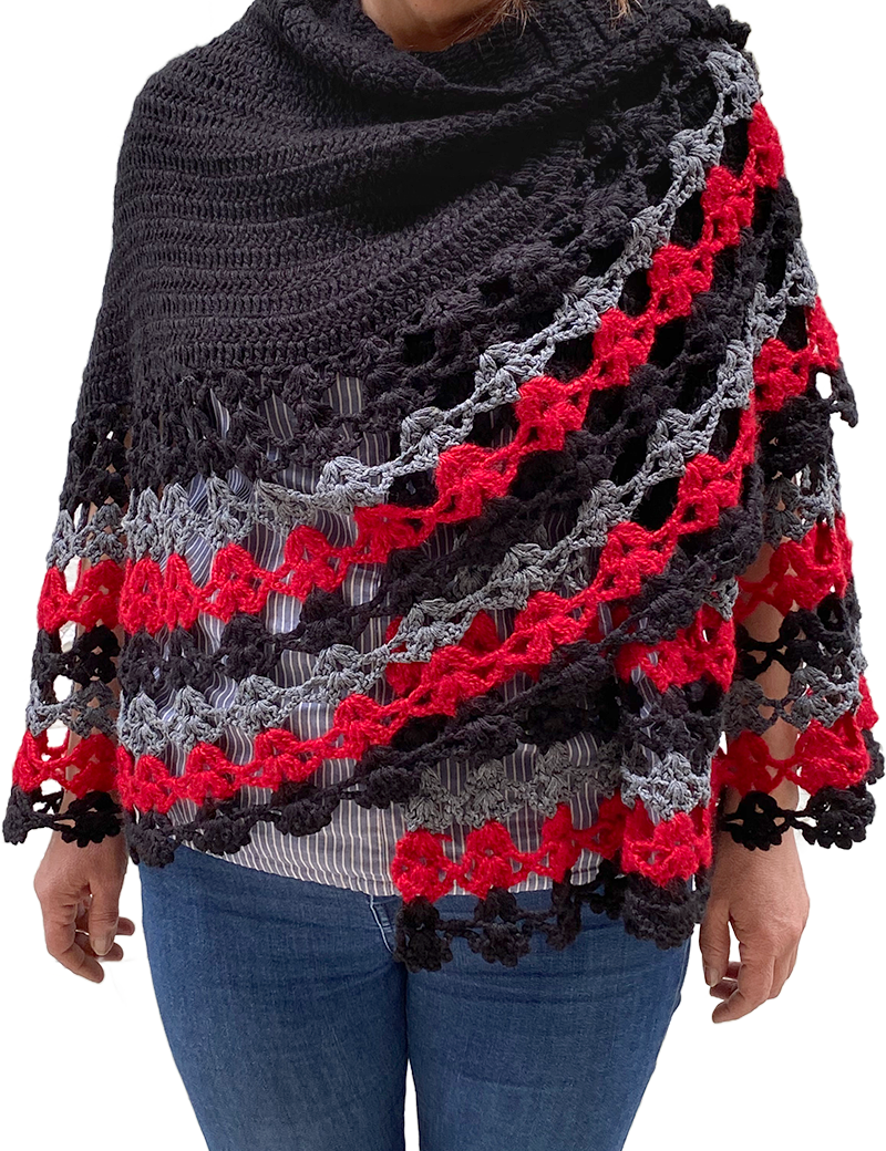 Detailed view of crochet capelet texture and color-blocking on model.