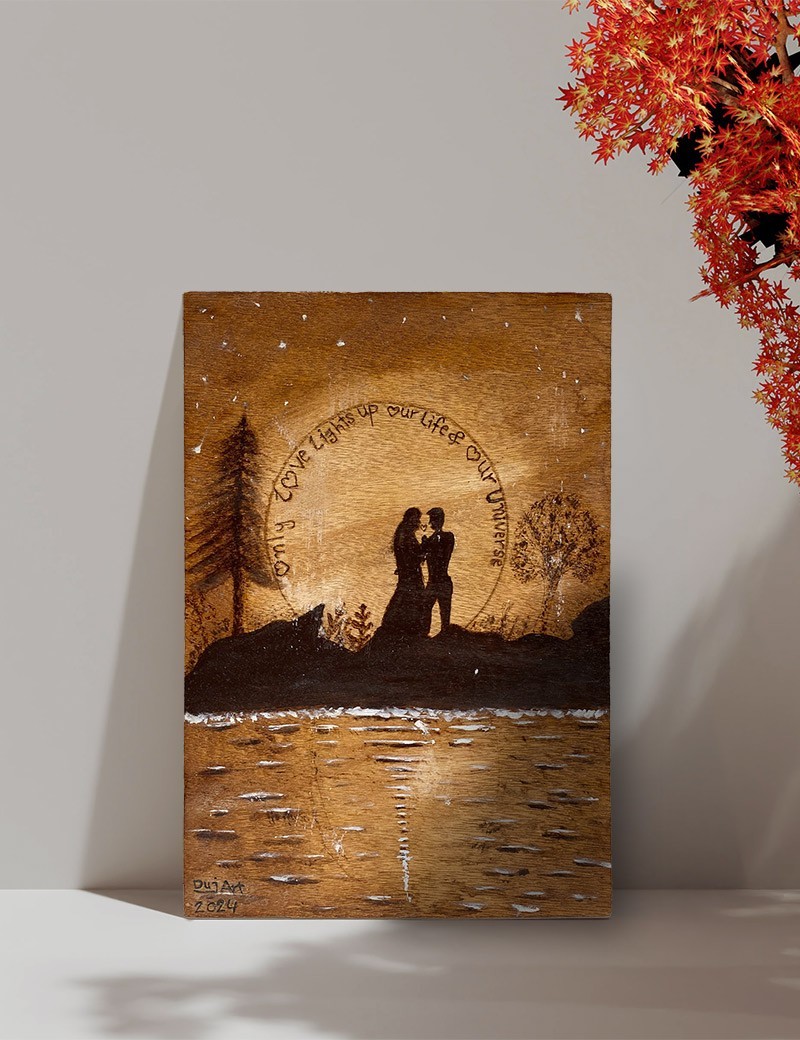 Woodburned A4 art of lovers silhouette under a moonlit sky.