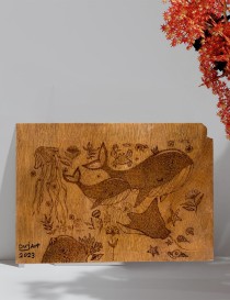 Marine life pyrography artwork displayed on a wall.