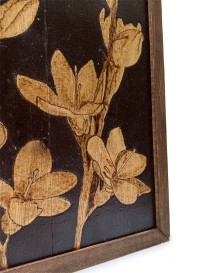 Detailed view of the dark wood frame and textured woodburning finish.