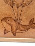 Detailed view of a smiling woodburned dolphin and ribbon knot.