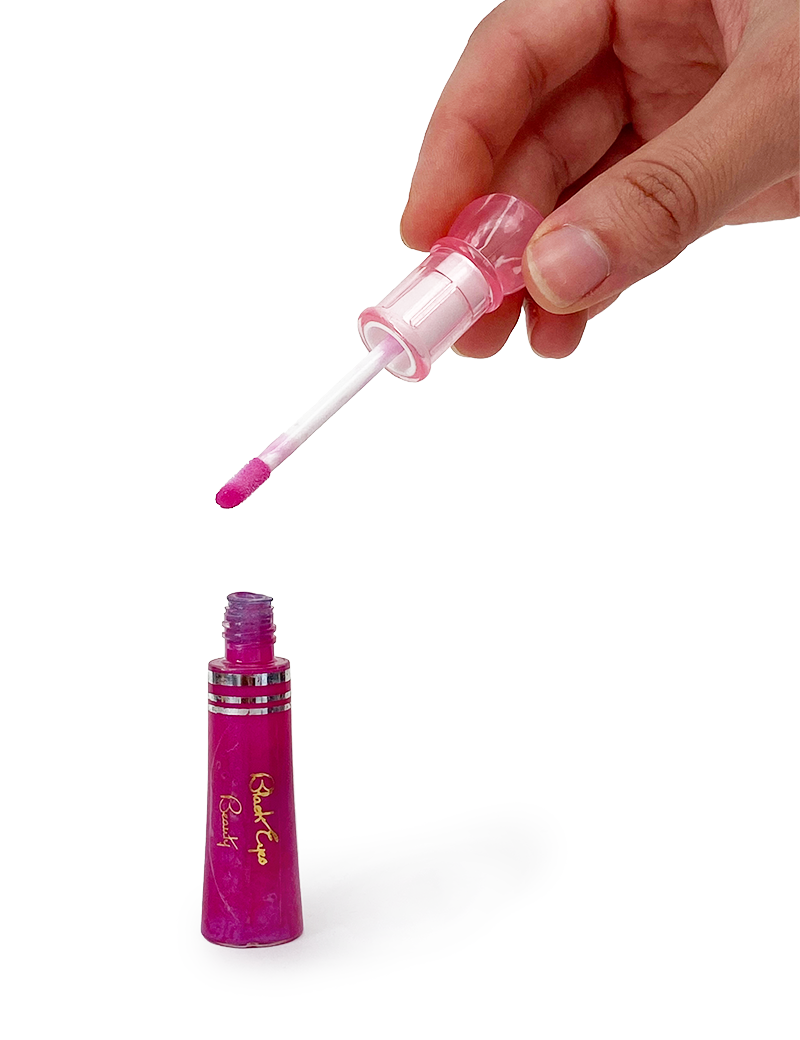 Hand holding open fuchsia pink lip gloss wand over 15ml bottle.