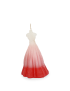 Front view of a white and red ombré wedding dress-shaped scented candle with a cotton wick.