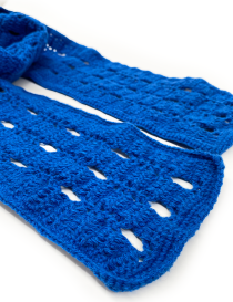 Detailed shot of the artisanal crochet craftsmanship and wool thread texture of the blue scarf.