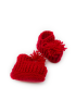 Top-down view of red rib-knit crochet toddler booties showing texture and stretch.