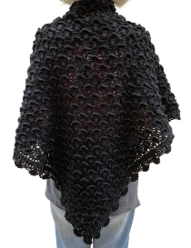 Rear view of a woman wearing a black triangular crochet wrap.