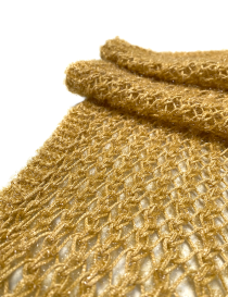 Detailed view of shimmering golden yarn and mesh texture.