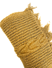Flat lay of golden knit fabric showing metallic thread shine.