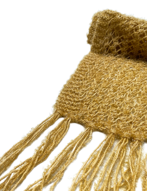 Close-up of hand-tied golden fringe and tassel details.