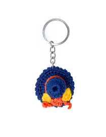 Blue handmade crochet hat keychain with orange floral accent.