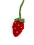 Close-up of a 3D red crochet strawberry with white embroidered seeds.