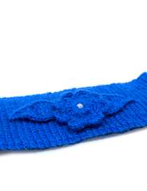 Close-up of handmade crochet flower detail with Dakron stuffing and pearl accessory.