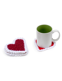 Stack of red heart-shaped crochet coasters next to a white coffee mug.