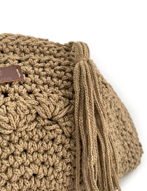 Macro shot of the thick, hand-braided cord tassel attached to the zipper.