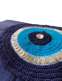 Close-up of crocheted blue eye motif with sequins and crystal centerpiece.