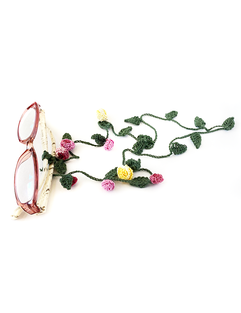 Handmade crochet glasses chain with pink and yellow silk roses attached to pink frames.