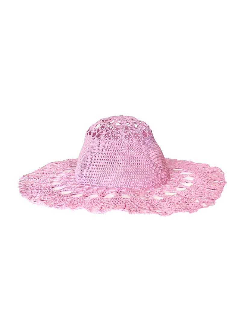 Profile view of a wide-brimmed pink crochet sun hat for women.