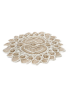 Perspective view of lace doily lying flat on a white surface.