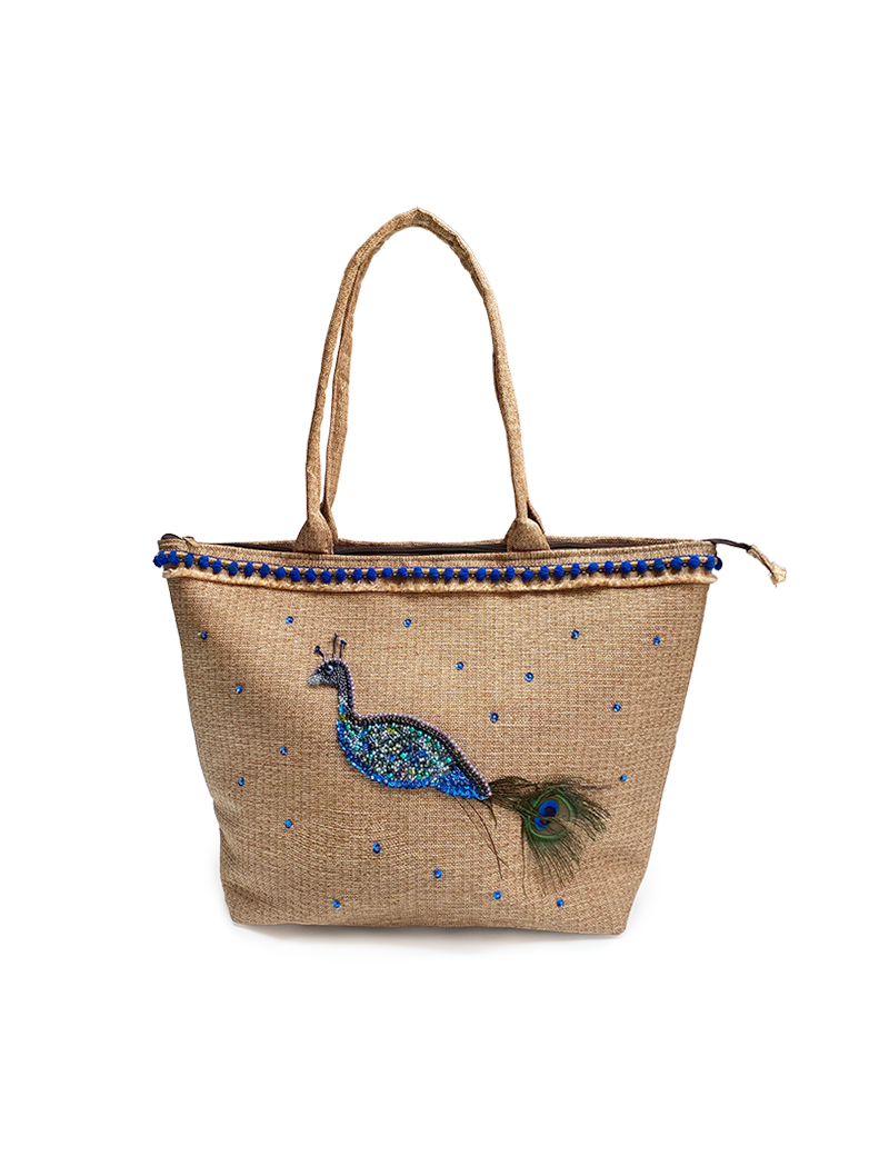 Hand-embroidered peacock jute tote bag with blue pom-pom trim.