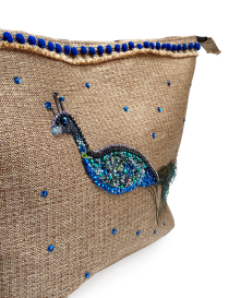 Macro shot of intricate blue and green beads on the peacock motif.