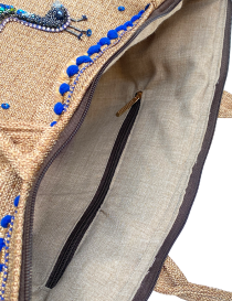 Interior of the jute bag showing fabric lining and zipper pocket.