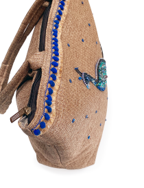 Top view of the secure zipper closure and pom-pom detailing.