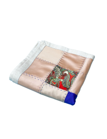 Folded Syrian textile showing paisley and satin fabric patches.