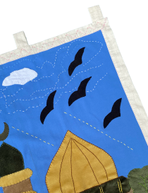 Hand-stitched blue sky detail with black bird silhouettes and white clouds.