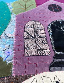 Intricate patchwork detail showing various fabric patterns and stitch types.