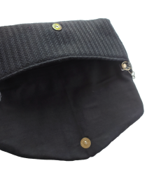Interior view of black bag showing magnetic snap closure and soft lining.