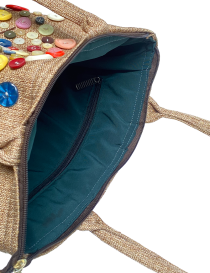 Interior teal lining and zipper pocket of jute bag.