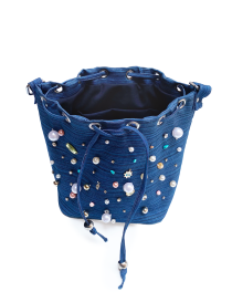 Top view of denim bag showing metal rings and interior space.