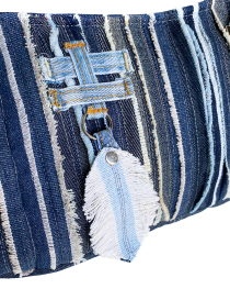 Detail of the denim feather charm and frayed fabric layers.