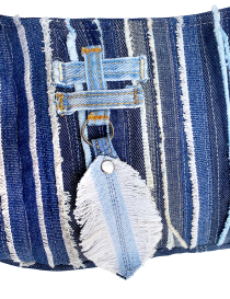 Macro shot of the handcrafted denim feather accessory.