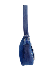 Profile view of the denim bag and reinforced shoulder strap.