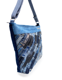 Side profile of the slim-style Rima denim crossbody bag.