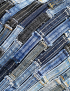 Detailed closeup of the woven denim belt loops in various blue shades.