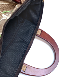 Interior view of black lining and internal zippered pocket.