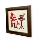 Side angle of the dark wooden frame with tea silhouette needlepoint.