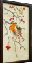 Side view of dark wood frame for bird cross-stitch art.
