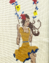 Detailed view of colorful cross-stitch embroidery and floral swing.