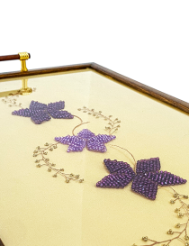 Detail of golden and copper handles on a traditional Syrian serving tray.