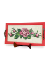 Front view of handmade red wooden tray with pink rose cross-stitch embroidery.