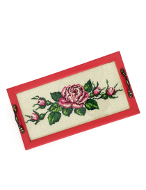 Overhead view of rectangular floral serving tray with ornate bronze handles.