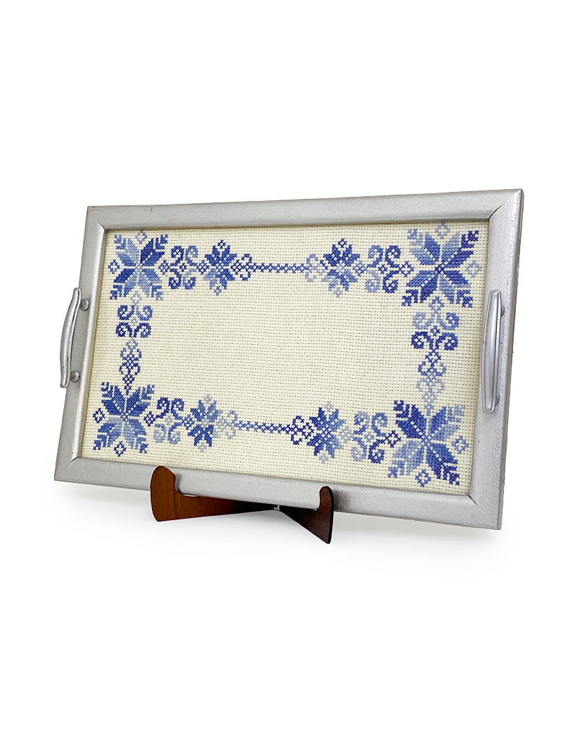 Hand-stitched blue floral wooden tray on display stand for Syrian home decor.