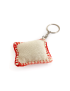Rear view of cream canvas handmade keychain with red stitched border.