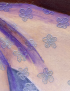 Close-up of 3D metallic floral patterns on painted canvas.