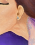 Detail of painted silver earring and lace on woman portrait.