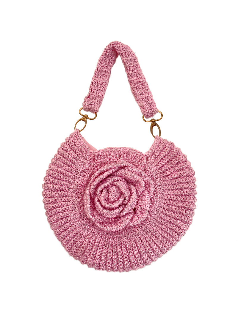 Front view of a pink rosette crochet handbag with a 3D floral design and loop handle.