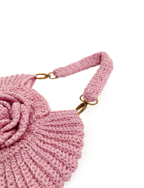 Close-up of the antique gold hardware and textured crochet stitching on the pink bag.